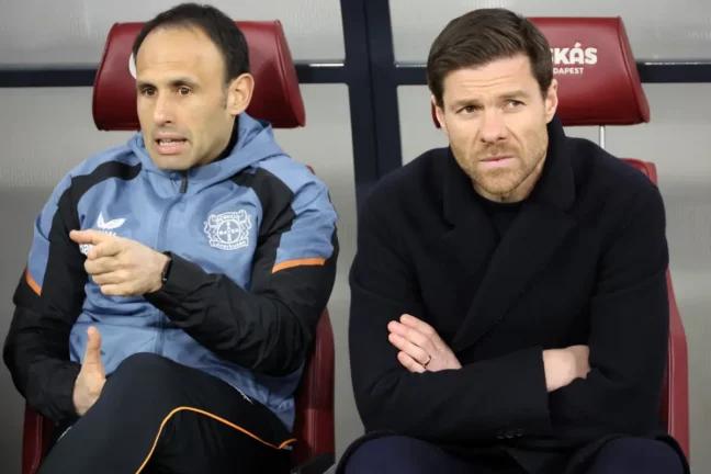 BUDAPEST, HUNGARY - MARCH 16: Sebastián Parrilla, Assistant Head Coach of Bayer 04 Leverkusen and Xabi Alonso, Head Coach of Bayer 04 Leverkusen, look on prior to the UEFA Europa League round of 16 leg two match between Ferencvarosi TC and Bayer 04 Leverkusen at Puskas Arena on March 16, 2023 in Budapest, Hungary. (Photo by Laszlo Szirtesi/Getty Images)