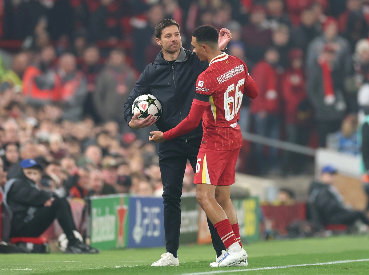 LIVERPOOL, ENGLAND - NOVEMBER 05: Xabi Alonso, Head Coach of Bayer 04 Leverkusen, and Trent Alexander-Arnold of Liverpool interact during the UEFA Champions League 2024/25 League Phase MD4 match between Liverpool FC and Bayer 04 Leverkusen at Anfield on
