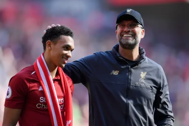 LIVERPOOL, ENGLAND - MAY 12: Jurgen Klopp, Manager of Liverpool embraces Trent Alexander-Arnold of Liverpool after the Premier League match between Liverpool FC and Wolverhampton Wanderers at Anfield on May 12, 2019 in Liverpool, United Kingdom. (Photo by Laurence Griffiths/Getty Images)