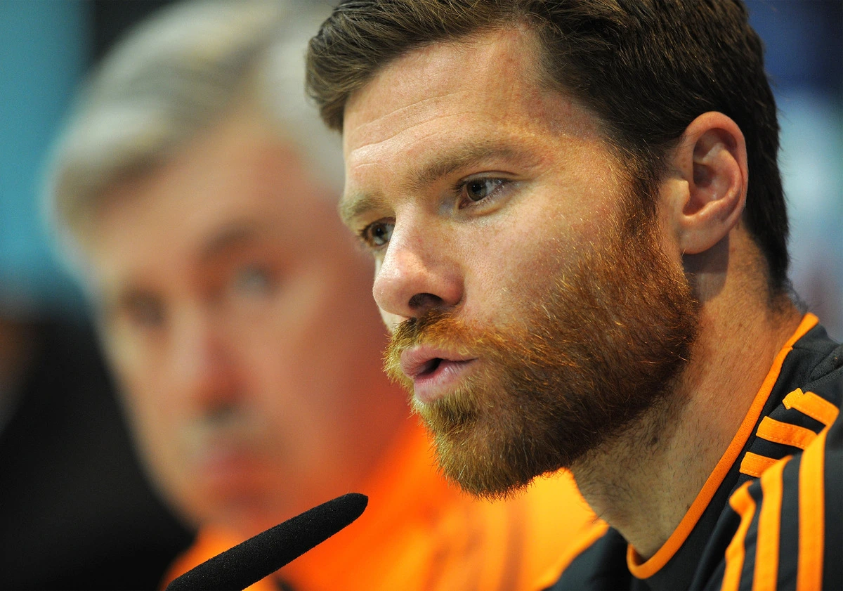 MADRID, SPAIN - APRIL 22: Xabi Alonso (R) of Real Madrid CF answers a question beside head coach Carlo Ancelotti during their press conference at Valdebebas training ground ahead of the UEFA Champions League semi-final first leg match against Bayern Munich on April 22, 2014 in Madrid, Spain. (Photo by Denis Doyle/Getty Images)