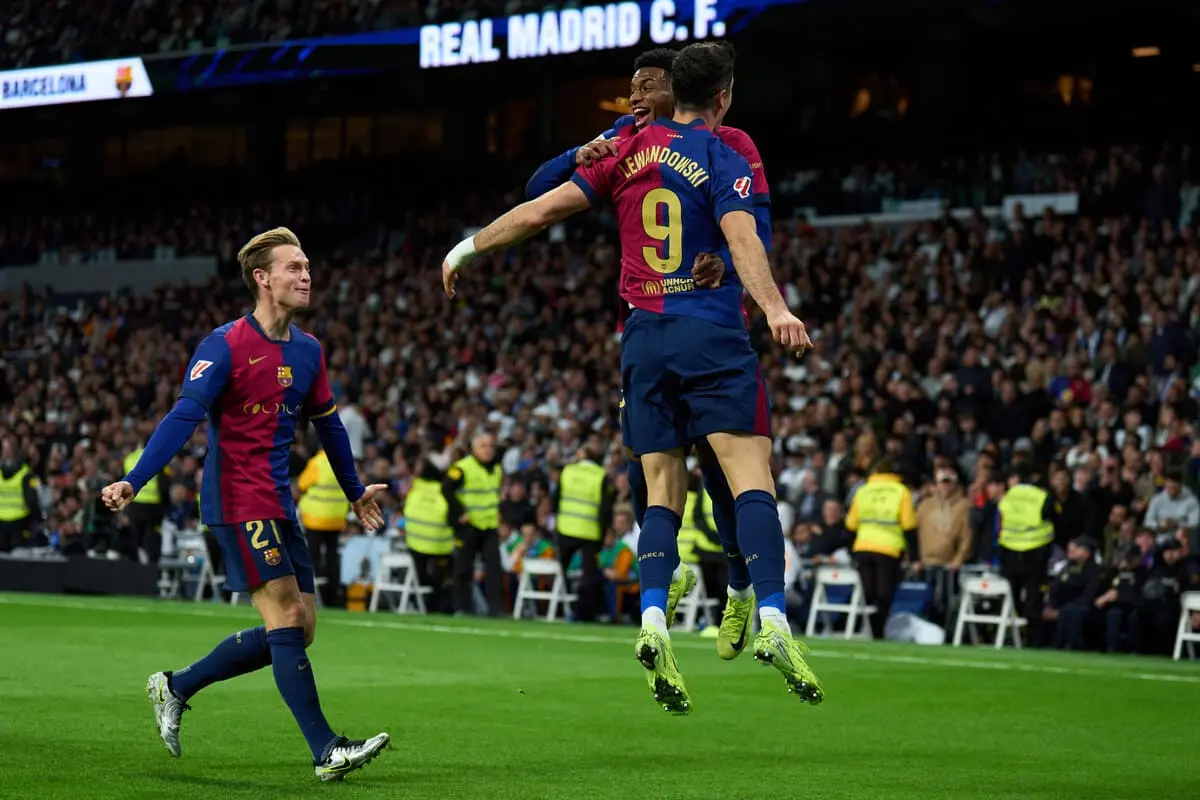 MADRID, SPAIN - OCTOBER 26: Robert Lewandowski of FC Barcelone celebrates with Alejandro Balde after scoring the team's second goal during the LaLiga match between Real Madrid CF and FC Barcelona at Estadio Santiago Bernabeu on October 26, 2024 in Madrid, Spain. (Photo by Angel