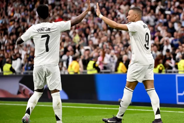 MADRID, SPAIN - MAY 04: Kylian Mbappe of Real Madrid celebrates scoring his team's third goal with teammate Vinicius Junior during the LaLiga match between Real Madrid CF and RC Celta de Vigo at Estadio Santiago Bernabeu on May 04, 2025 in Madrid, Spain. (Photo by Denis Doyle/Getty Images)