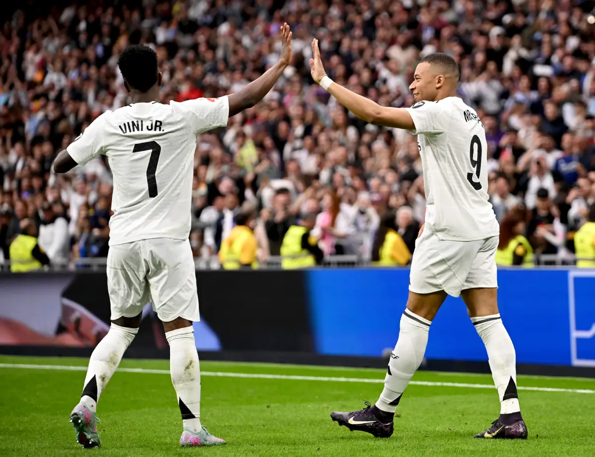 MADRID, SPAIN - MAY 04: Kylian Mbappe of Real Madrid celebrates scoring his team's third goal with teammate Vinicius Junior during the LaLiga match between Real Madrid CF and RC Celta de Vigo at Estadio Santiago Bernabeu on May 04, 2025 in Madrid, Spain. (Photo by Denis Doyle/Getty Images)