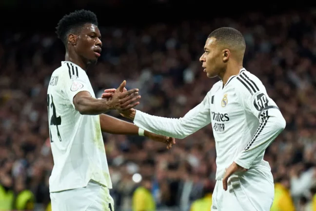 MADRID, SPAIN - JANUARY 16: Kylian Mbappe of Real Madrid celebrates scoring his team's first goal with Aurelien Tchouameni during the Copa Del Rey match between Real Madrid and Celta de Vigo at Estadio Santiago Bernabeu on January 16, 2025 in Madrid, Spain. (Photo by Angel Martinez/Getty Images).