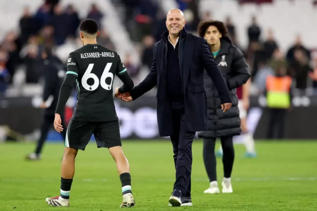 LONDON, ENGLAND - DECEMBER 29: Arne Slot, Manager of Liverpool, interacts with Trent Alexander-Arnold of Liverpool after the Premier League match between West Ham United FC and Liverpool FC at London Stadium on December 29, 2024 in London, England. (Photo by Julian Finney/Getty Images).