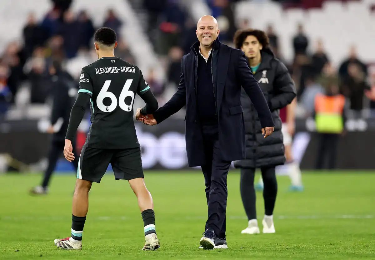 LONDON, ENGLAND - DECEMBER 29: Arne Slot, Manager of Liverpool, interacts with Trent Alexander-Arnold of Liverpool after the Premier League match between West Ham United FC and Liverpool FC at London Stadium on December 29, 2024 in London, England. (Photo by Julian Finney/Getty Images).