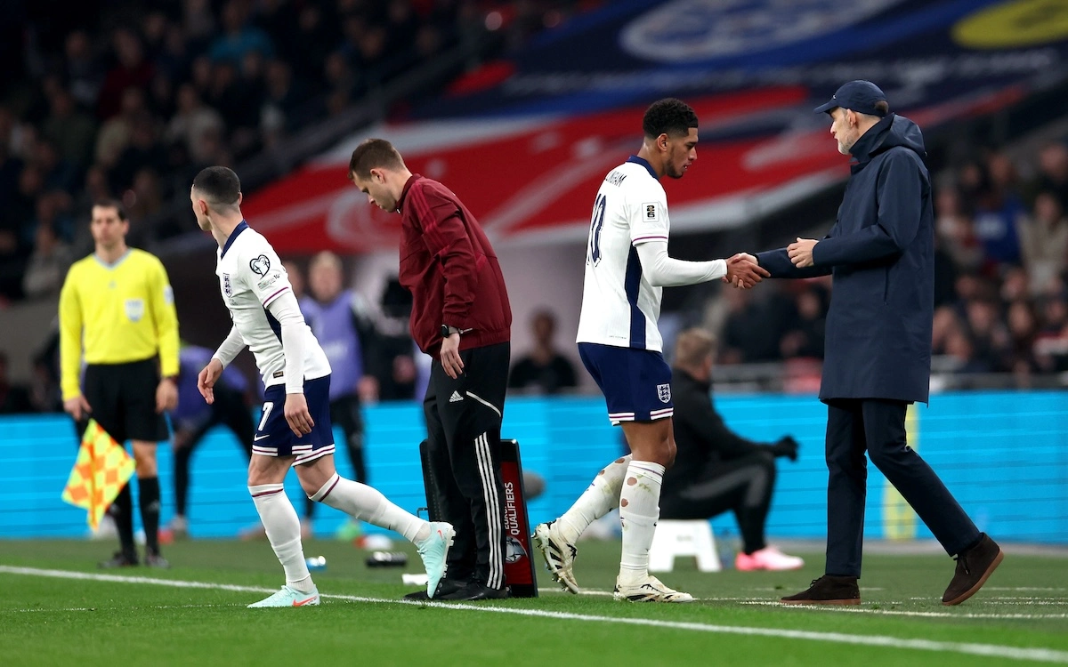 LONDON, ENGLAND - MARCH 24: Jude Bellingham of England shakes hands with Thomas Tuchel, Head Coach of England, after being substituted for teammate Phil Foden during the FIFA World Cup 2026 European Qualifier between England and Latvia at Wembley Stadium on March 24, 2025 in London, England. (Photo by Harry Murphy/Getty Images)