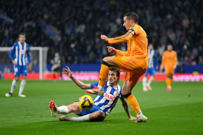 BARCELONA, SPAIN - FEBRUARY 01: Lucas Vazquez of Real Madrid is challenged by Carlos Romero of RCD Espanyol during the LaLiga match between RCD Espanyol de Barcelona and Real Madrid CF at RCDE Stadium on February 01, 2025 in Barcelona, Spain. (Photo by David Ramos/Getty Images)