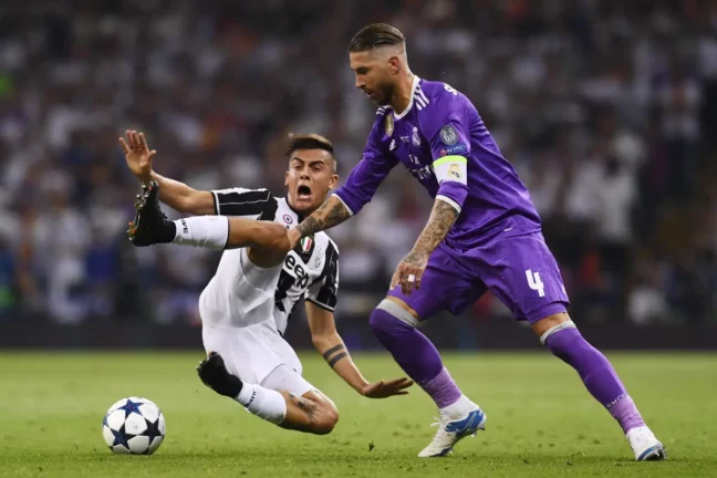 CARDIFF, WALES - JUNE 03: Paulo Dybala of Juventus and Sergio Ramos of Real Madrid battle for possession during the UEFA Champions League Final between Juventus and Real Madrid at National Stadium of Wales on June 3, 2017 in Cardiff, Wales. (Photo by David Ramos/Getty Images)