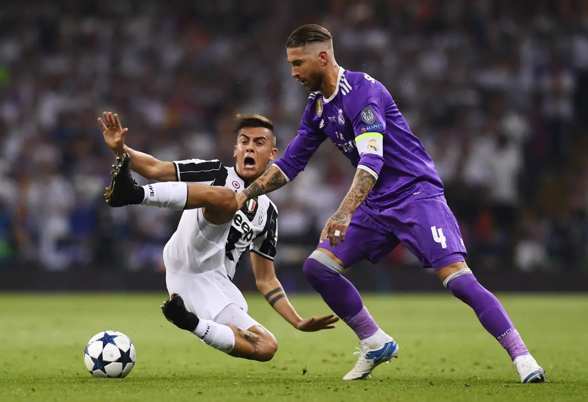 CARDIFF, WALES - JUNE 03: Paulo Dybala of Juventus and Sergio Ramos of Real Madrid battle for possession during the UEFA Champions League Final between Juventus and Real Madrid at National Stadium of Wales on June 3, 2017 in Cardiff, Wales. (Photo by David Ramos/Getty Images)