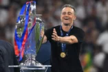 MUNICH, GERMANY - MAY 31: Luis Enrique, head coach of PSG excitedly reacts towards the trophy after the UEFA Champions League Final 2025 between Paris Saint-Germain and FC Internazionale Milano at on May 31, 2025 in Munich, Germany. (Photo by Stu Forster/Getty Images).