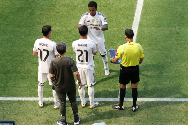 MIAMI GARDENS, FLORIDA - JUNE 18: Rodrygo #11 of Real Madrid C. F. greets Brahim Diaz #21 and Lucas Vazquez #17 on the sidelines during the FIFA Club World Cup 2025 group H match between Real Madrid CF and Al Hilal at Hard Rock Stadium on June 18, 2025 in Miami Gardens, Florida. (Photo by Sandra Montanez/Getty Images)