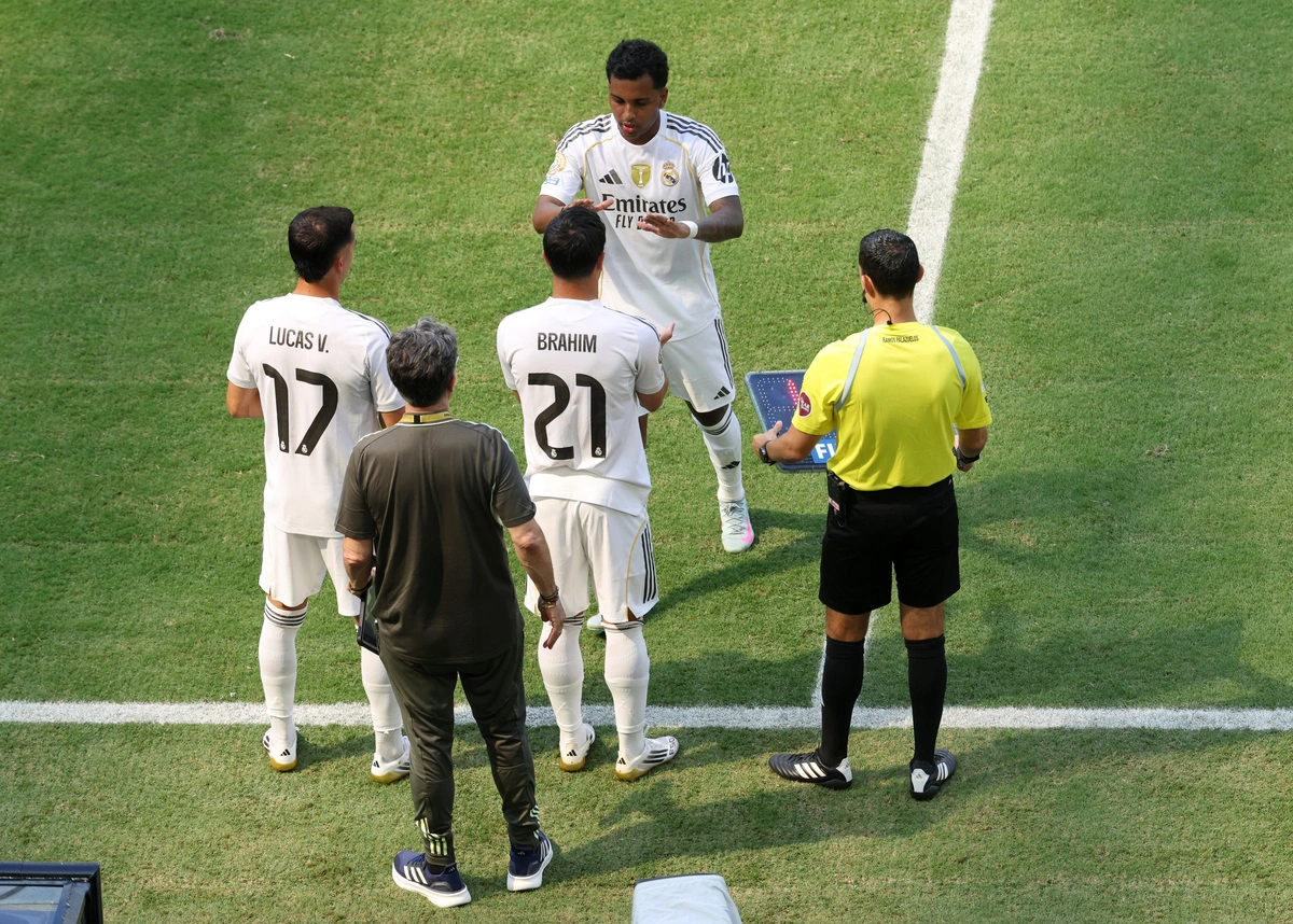 MIAMI GARDENS, FLORIDA - JUNE 18: Rodrygo #11 of Real Madrid C. F. greets Brahim Diaz #21 and Lucas Vazquez #17 on the sidelines during the FIFA Club World Cup 2025 group H match between Real Madrid CF and Al Hilal at Hard Rock Stadium on June 18, 2025 in Miami Gardens, Florida. (Photo by Sandra Montanez/Getty Images)