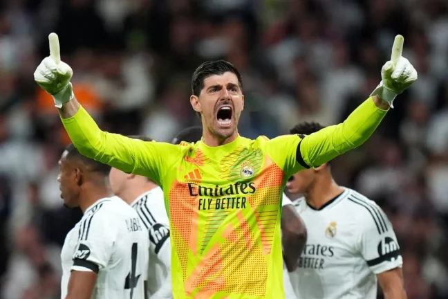 MADRID, SPAIN - APRIL 16: Thibaut Courtois of Real Madrid celebrates after saving a penalty kick from Bukayo Saka of Arsenal during the UEFA Champions League 2024/25 Quarter Final Second Leg match between Real Madrid C.F. and Arsenal FC at Estadio Santiago Bernabeu on April 16, 2025 in Madrid, Spain. (Photo by Angel Martinez/Getty Images)