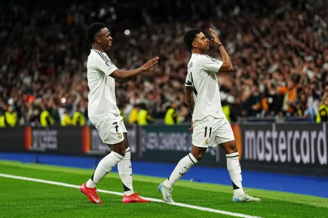 MADRID, SPAIN - MARCH 04: Rodrygo of Real Madrid celebrates scoring his team's first goal with teammate Vinicius Junior during the UEFA Champions League 2024/25 Round of 16 first leg match between Real Madrid C.F. and Atletico de Madrid at Santiago Bernabeu Stadium on March 04, 2025 in Madrid, Spain. (Photo by Aitor Alcalde/Getty Images)