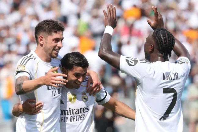 CHARLOTTE, NORTH CAROLINA - JUNE 22: Federico Valverde #8 of Real Madrid C. F. celebrates scoring his team's third goal with Brahim Diaz #21 and Vinicius Junior #7 of Real Madrid C. F. during the FIFA Club World Cup 2025 group H match between Real Madrid CF and CF Pachuca at Bank of America Stadium on June 22, 2025 in Charlotte, North Carolina. (Photo by Richard Pelham/Getty Images)
