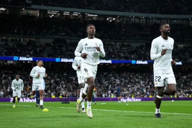 MADRID, SPAIN - OCTOBER 26: Eduardo Camavinga and Antonio Ruediger of Real Madrid warm up prior to the LaLiga match between Real Madrid CF and FC Barcelona at Estadio Santiago Bernabeu on October 26, 2024 in Madrid, Spain. (Photo by Angel Martinez/Getty Images).