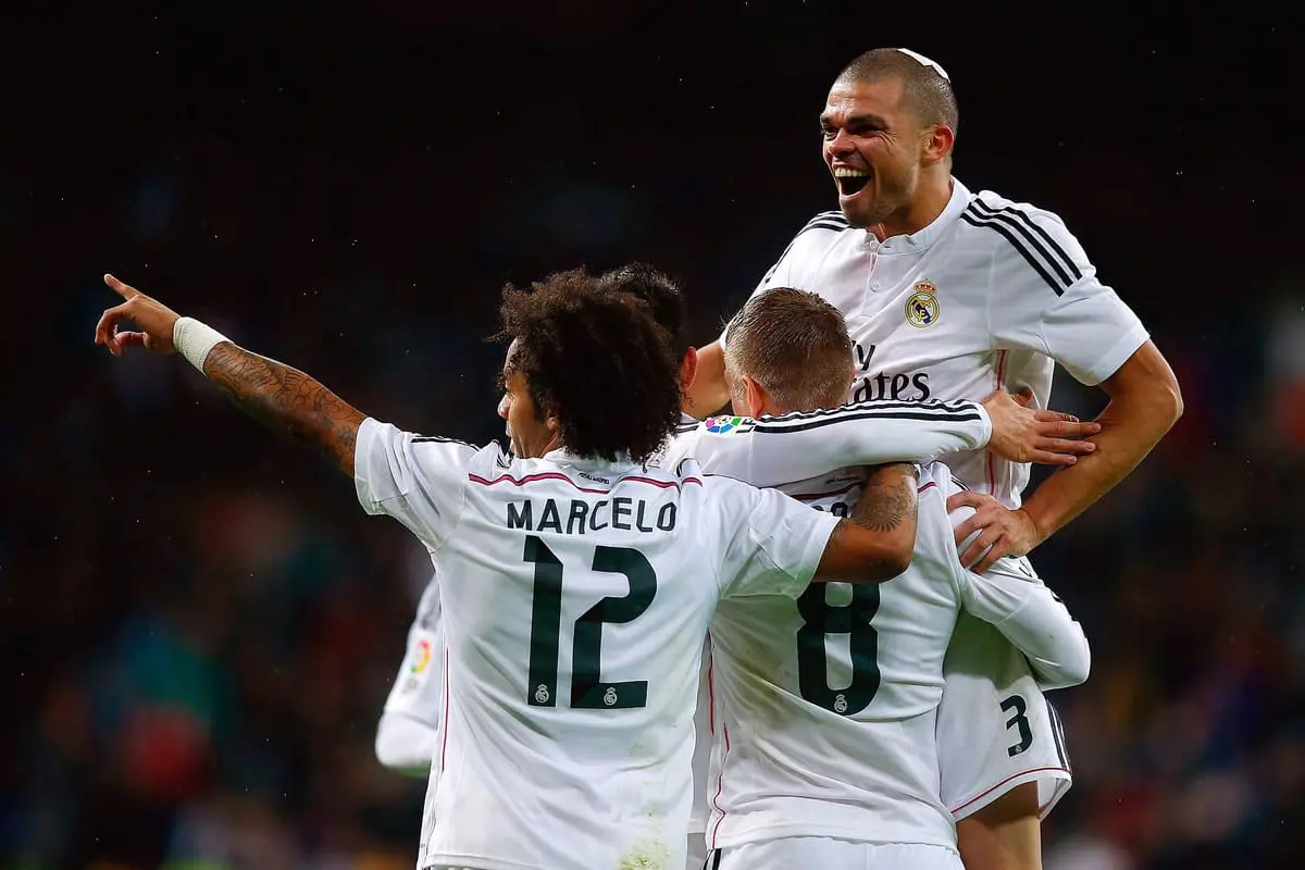 MADRID, SPAIN - NOVEMBER 08: Toni Kroos (2ndR) celebrates scoring their third goal with teammates Pepe (R) and Marcelo (L) during the La Liga match between Real Madrid CF and Rayo Vallecano de Madrid at Estadio Santiago Bernabeu on November 8, 2014 in Madrid, Spain. (Photo by Gonzalo Arroyo Moreno/Getty Images)