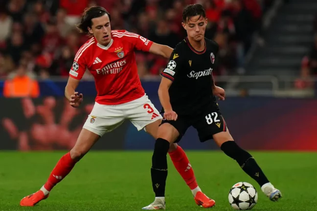 LISBON, PORTUGAL - DECEMBER 11: Kacper Urbanski of Bologna FC 1909 with Alvaro Carreras of SL Benfica in action during the UEFA Champions League 2024/25 League Phase MD6 match between SL Benfica and Bologna FC 1909 at Estadio da Luz on December 11, 2024 in Lisbon, Portugal. (Photo by Gualter Fatia/Getty Images)