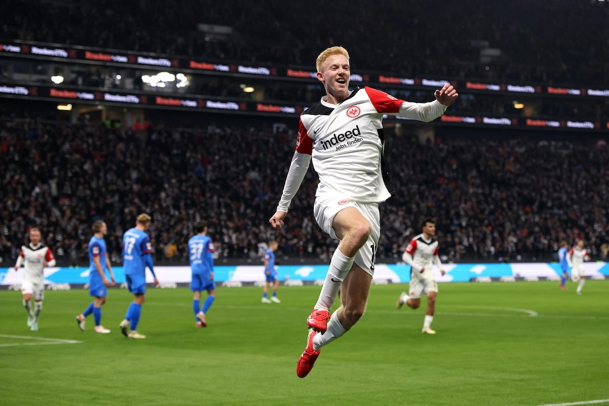 FRANKFURT AM MAIN, GERMANY - FEBRUARY 16: Hugo Larsson of Eintracht Frankfurt celebrates scoring his team's first goal during the Bundesliga match between Eintracht Frankfurt and Holstein Kiel at Deutsche Bank Park on February 16, 2025 in Frankfurt am Main, Germany. (Photo by Alex Grimm/Getty Images) l Real Madrid