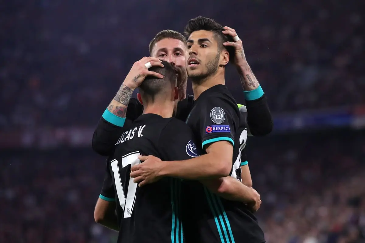 MUNICH, GERMANY - APRIL 25: Marco Asensio of Real Madrid celebrates with Sergio Ramos and Lucas Vazquez after scoring his sides second goal during the UEFA Champions League Semi Final First Leg match between Bayern Muenchen and Real Madrid at the Allianz Arena on April 25, 2018 in Munich, Germany. (Photo by Alexander Hassenstein/Bongarts/Getty Images)