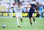 EAST RUTHERFORD, NEW JERSEY - JULY 09: Federico Valverde #8 of Real Madrid C. F. is challenged by Khvicha Kvaratskhelia #7 of Paris Saint-Germain during the FIFA Club World Cup 2025 semi-final match between Winner Game 59 and Winner Game 60 at MetLife Stadium on July 09, 2025 in East Rutherford, New Jersey. (Photo by Alex Grimm/Getty Images)
