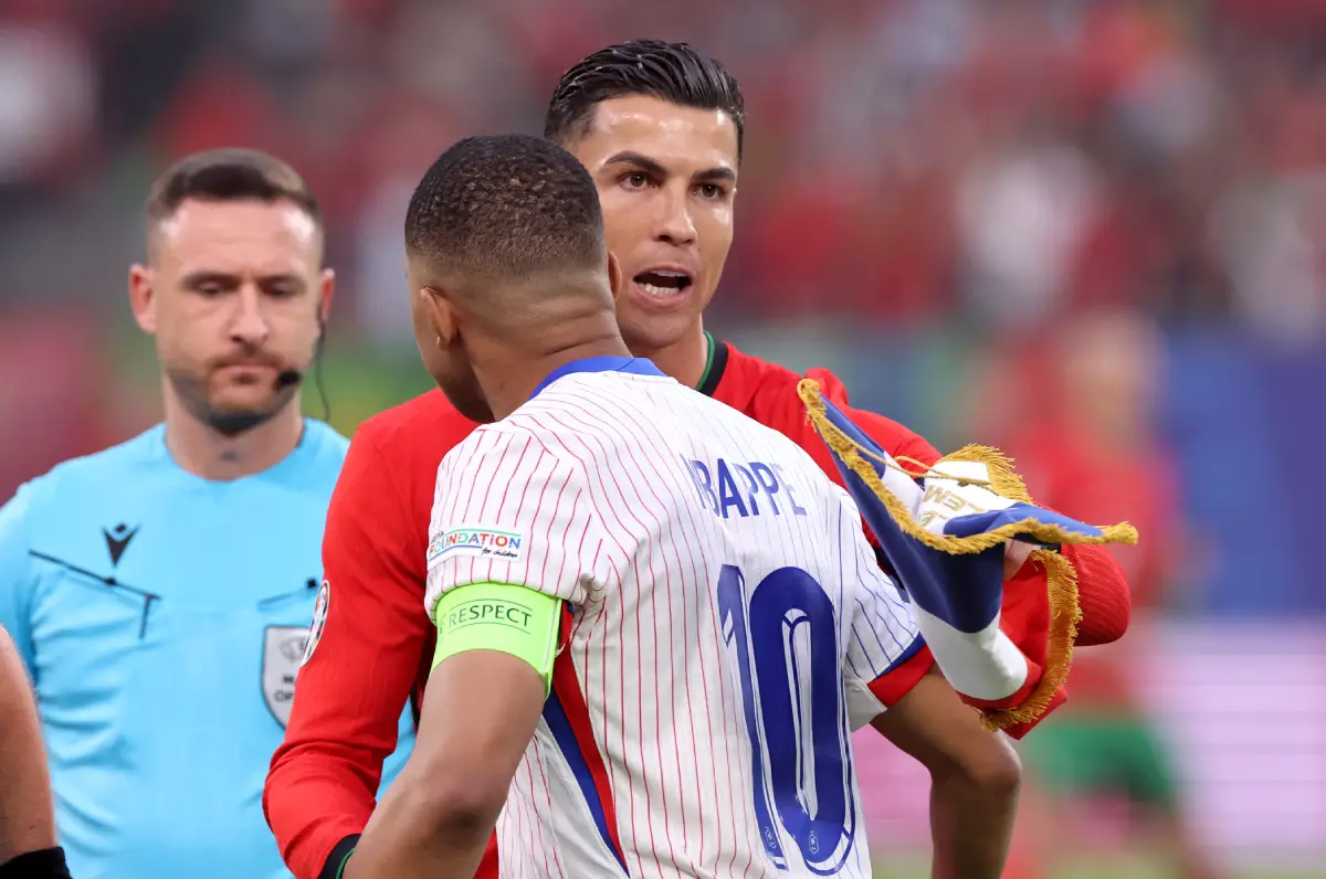 HAMBURG, GERMANY - JULY 05: Cristiano Ronaldo of Portugal interacts with Kylian Mbappe of France prior to the UEFA EURO 2024 quarter-final match between Portugal and France at Volksparkstadion on July 05, 2024 in Hamburg, Germany. (Photo by Alex Grimm/Getty Images)
