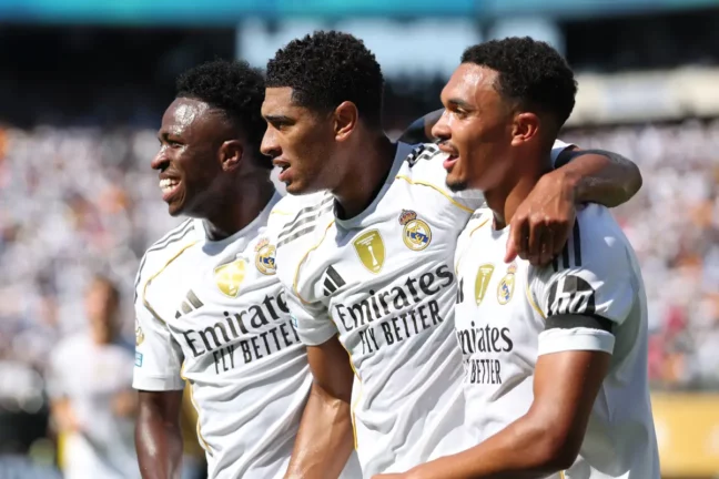 EAST RUTHERFORD, NEW JERSEY - JULY 05: Vinicius Junior #7, Jude Bellingham #5, and Trent Alexander-Arnold #12 of Real Madrid C.F. celebrate after Fran Garcia #20 (not pictured) scores his team's second goal during the FIFA Club World Cup 2025 quarter-final match between Real Madrid CF and Borussia Dortmund at MetLife Stadium on July 05, 2025 in East Rutherford, New Jersey. (Photo by Francois Nel/Getty Images)