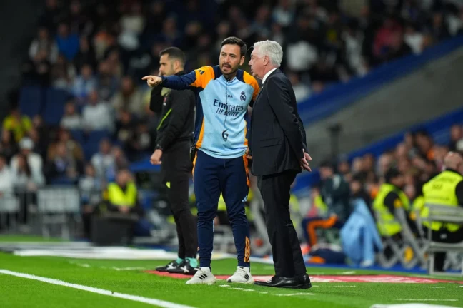 MADRID, SPAIN - MAY 14: Davide Ancelotti, Assistant Manager of Real Madrid, speaks with Carlo Ancelotti, Head Coach of Real Madrid, during the LaLiga match between Real Madrid CF and RCD Mallorca at Estadio Santiago Bernabeu on May 14, 2025 in Madrid, Spain. (Photo by Angel