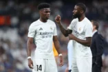 MADRID, SPAIN - OCTOBER 05: Antonio Rudiger (R) of Real Madrid CF speaks with his teammate Aurelien Tchouameni (L) during their warm up before the LaLiga match between Real Madrid CF and Villarreal CF at Estadio Santiago Bernabeu on October 05, 2024 in Madrid, Spain. (Photo by Gonzalo Arroyo Moreno/Getty Images).
