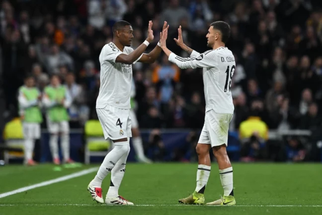MADRID, SPAIN - JANUARY 22: David Alaba of Real Madrid interacts with Dani Ceballos as he leaves the field whilst being substituted during the UEFA Champions League 2024/25 League Phase MD7 match between Real Madrid C.F. and FC Salzburg at Estadio Santiago Bernabeu on January 22, 2025 in Madrid, Spain. (Photo by Denis Doyle/Getty Images)