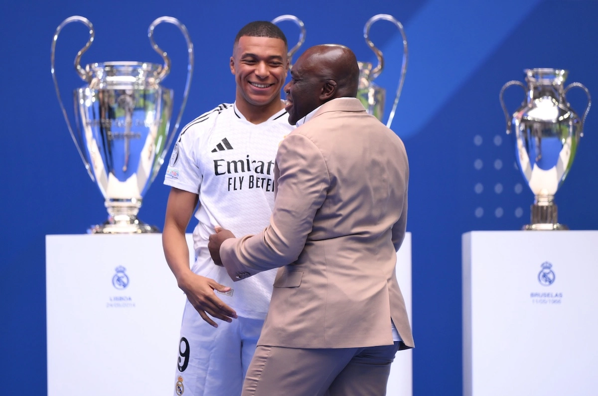 MADRID, SPAIN - JULY 16: Real Madrid new signing, Kylian Mbappe interacts with his father, Wilfried Mbappe as he is unveiled at Estadio Santiago Bernabeu on July 16, 2024 in Madrid, Spain. (Photo by David Ramos/Getty Images)
