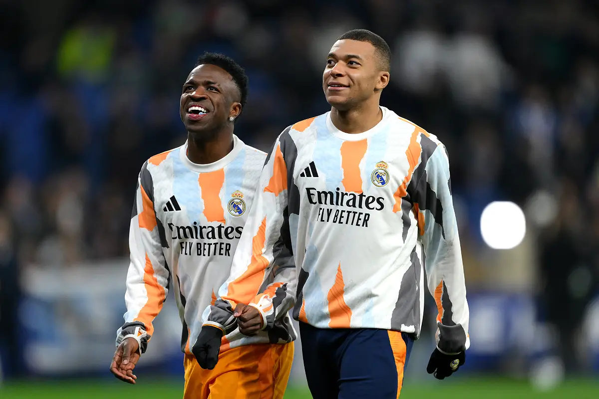 BARCELONA, SPAIN - FEBRUARY 01: Vinicius Junior and Kylian Mbappe of Real Madrid smile on pitch prior to the LaLiga match between RCD Espanyol de Barcelona and Real Madrid CF at RCDE Stadium on February 01, 2025 in Barcelona, Spain. (Photo by David Ramos/Getty Images)