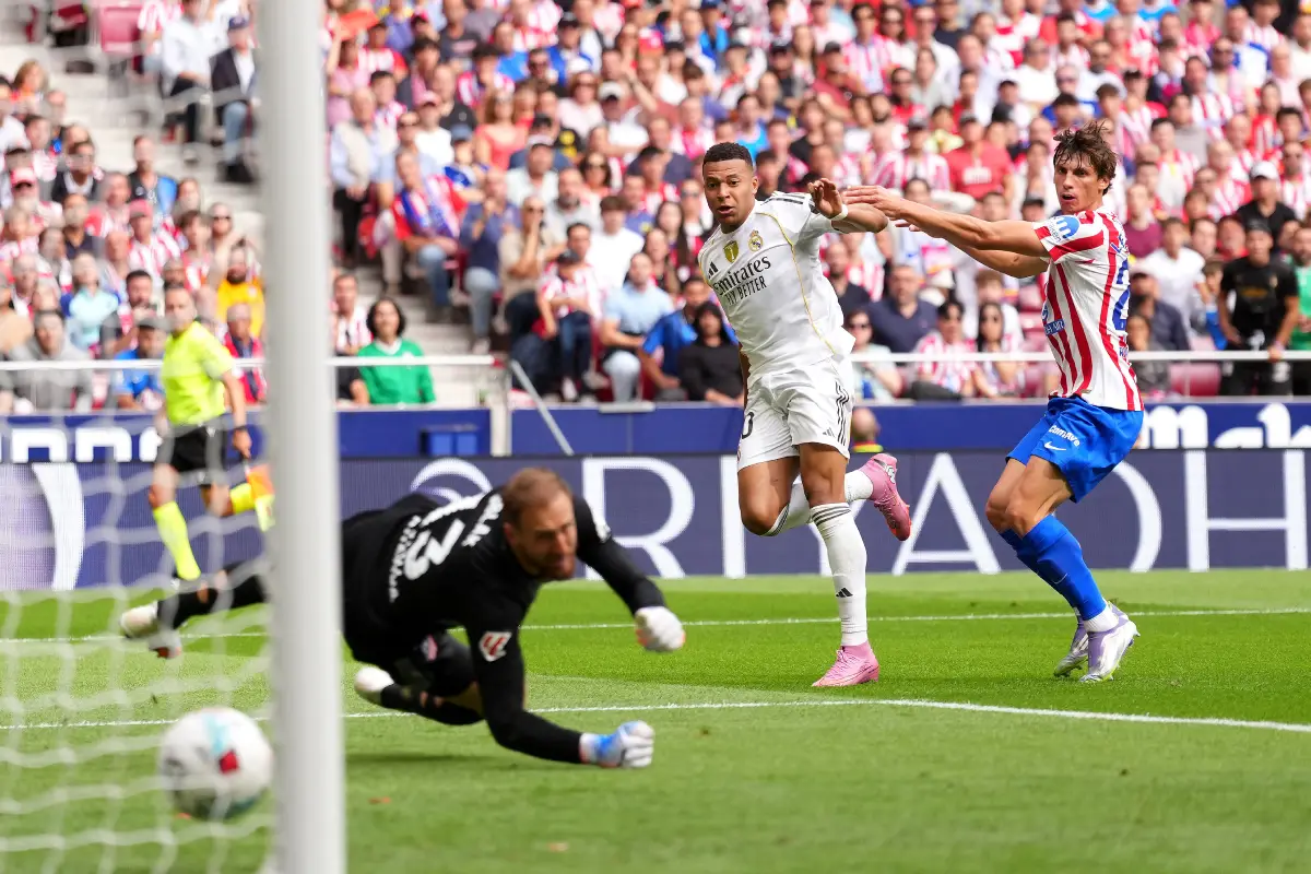 MADRID, SPAIN - SEPTEMBER 27: Kylian Mbappe of Real Madrid scores his team's first goal past goalkeeper Jan Oblak of Atletico de Madrid during the LaLiga EA Sports match between Atletico de Madrid and Real Madrid CF at Riyadh Air Metropolitano on September 27, 2025 in Madrid, Spain. (Photo by Angel Martinez/Getty Images)