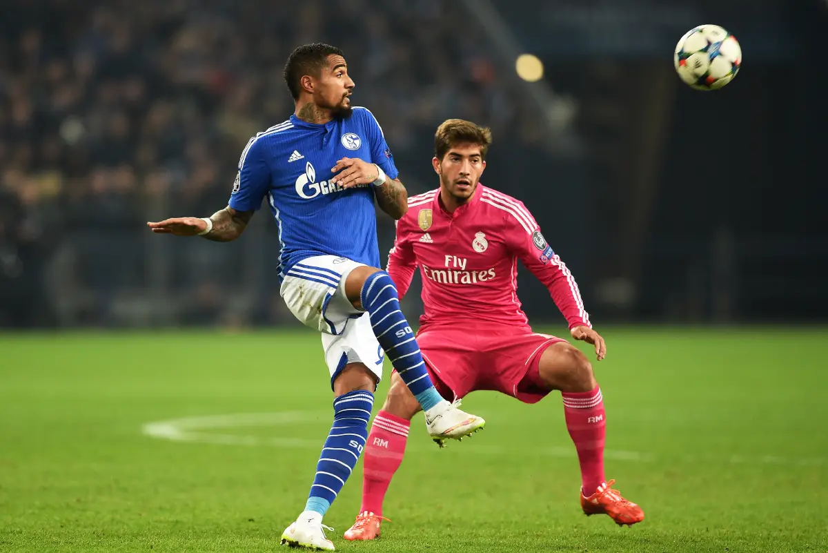 GELSENKIRCHEN, GERMANY - FEBRUARY 18: Kevin-Prince Boateng of Schalke passes the ball as Lucas Silva of Real Madrid closes in during the UEFA Champions League Round of 16 match between FC Schalke 04 and Real Madrid at the Veltins-Arena on February 18, 2015 in Gelsenkirchen, Germany. (Photo by Dennis Grombkowski/Bongarts/Getty Images)