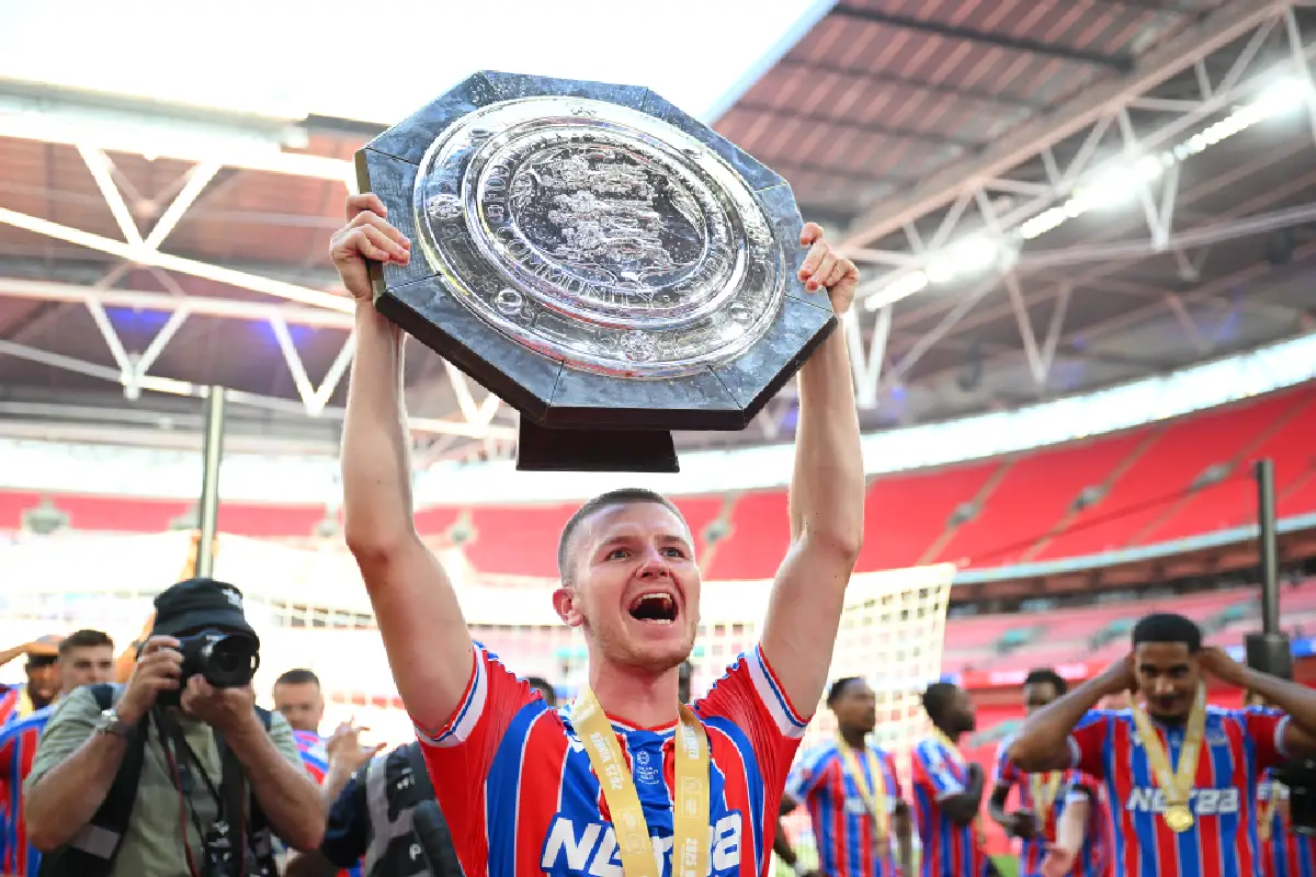 LONDON, ENGLAND - AUGUST 10: Adam Wharton of Crystal Palace holds the trophy aloft after their victory in the 2025 FA Community Shield match between Crystal Palace and Liverpool at Wembley Stadium on August 10, 2025 in London, England. (Photo by Clive Mason/Getty Images)