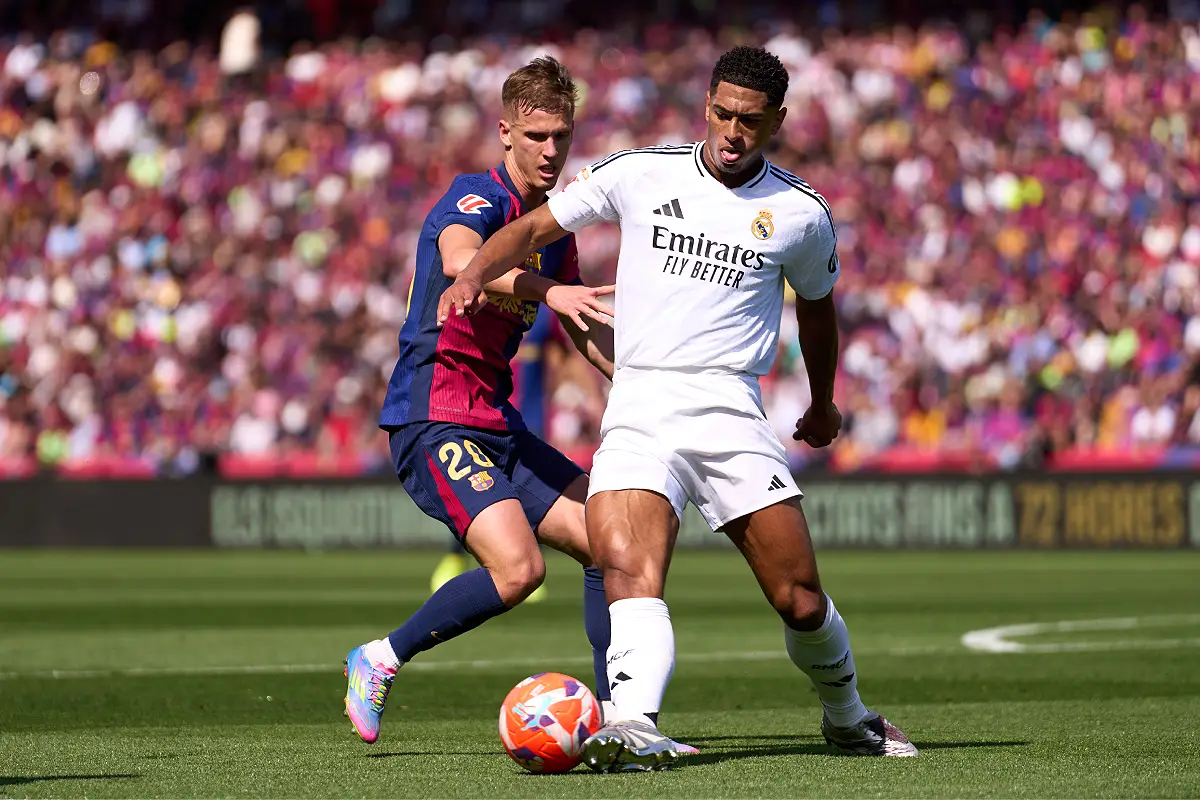 BARCELONA, SPAIN - MAY 11: Jude Bellingham of Real Madrid CF is challenged by Dani Olmo of FC Barcelona during the LaLiga match between FC Barcelona and Real Madrid CF at Estadi Olimpic Lluis Companys on May 11, 2025 in Barcelona, Spain. (Photo by Alex Caparros/Getty Images)