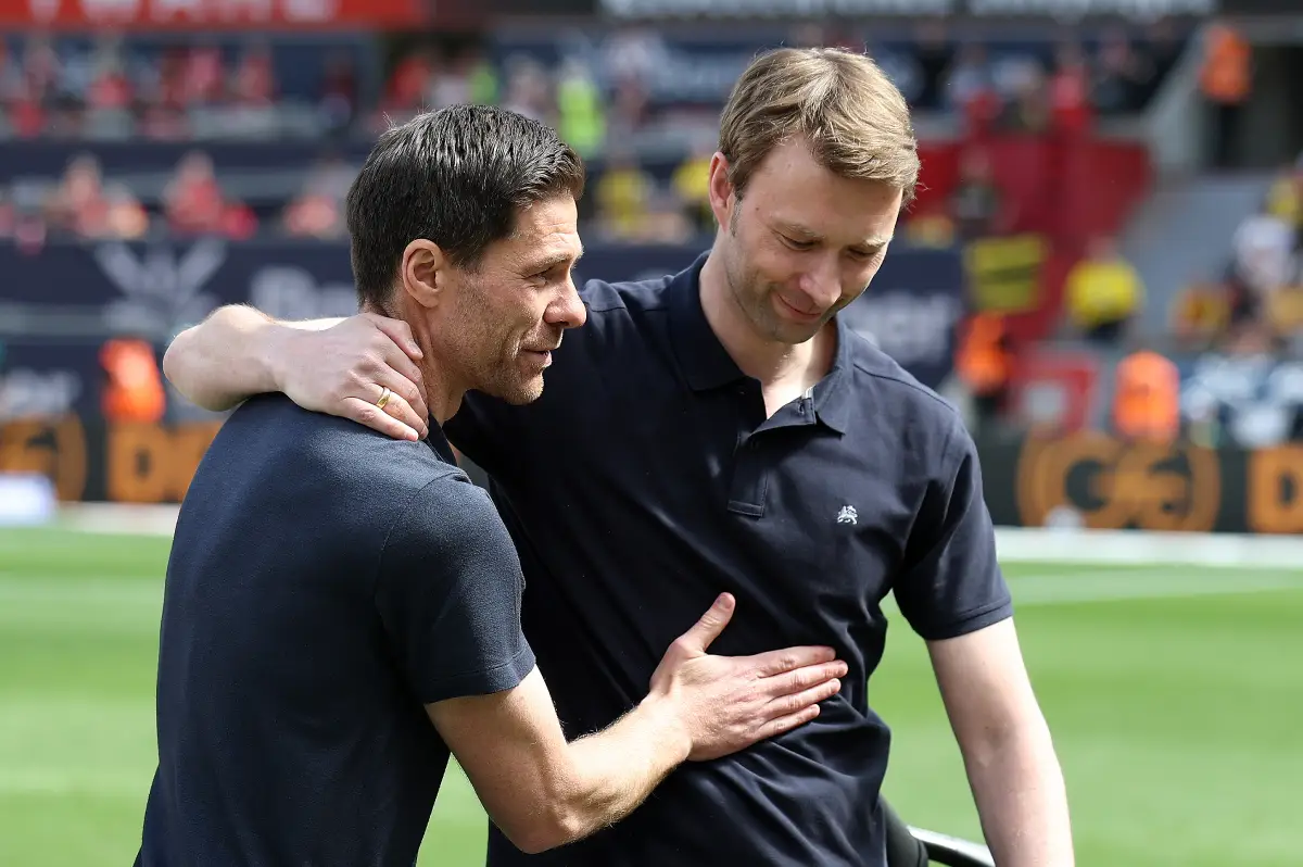 LEVERKUSEN, GERMANY - MAY 11: Xabi Alonso, Head Coach of Bayer 04 Leverkusen interacts with Managing director of sport for Bayer Leverkusen, Simon Rolfes ahead of his last home game prior to the Bundesliga match between Bayer 04 Leverkusen and Borussia Dortmund at BayArena on May 11, 2025 in Leverkusen, Germany. (Photo by Lars Baron/Getty Images)