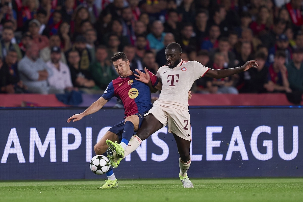 BARCELONA, SPAIN - OCTOBER 23: Robert Lewandowski of FC Barcelona competes for the ball with Dayot Upamecano of FC Bayern Munchen during the UEFA Champions League 2024/25 League Phase MD3 match between FC Barcelona and FC Bayern Munchen at Estadi Olimpic Lluis Companys on October 23, 2024 in Barcelona, Spain. (Photo by Pedro Salado/Getty Images) l Real Madrid