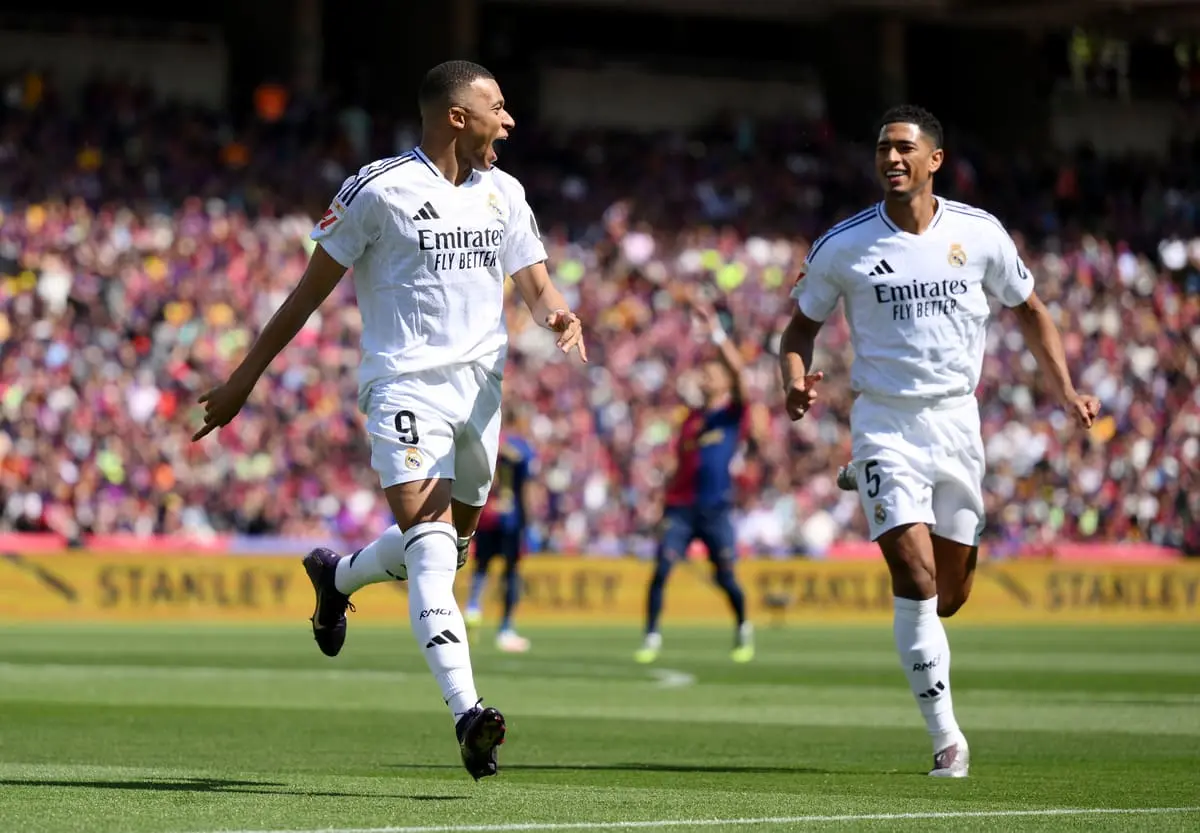 BARCELONA, SPAIN - MAY 11: Kylian Mbappe of Real Madrid celebrates scoring his team's first goal with teammate Jude Bellingham during the LaLiga match between FC Barcelona and Real Madrid CF at Estadi Olimpic Lluis Companys on May 11, 2025 in Barcelona, Spain. (Photo by David Ramos/Getty Images)