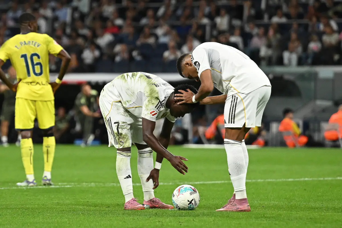 MADRID, SPAIN - OCTOBER 04: Kylian Mbappe (R) of Real Madrid has a word with his teammate Vinicius Junior prior to Vinicius converting his penalty kick to score Real's second goal during the LaLiga EA Sports match between Real Madrid CF and Villarreal CF at Estadio Santiago Bernabeu on October 04, 2025 in Madrid, Spain. (Photo by Denis Doyle/Getty Images)