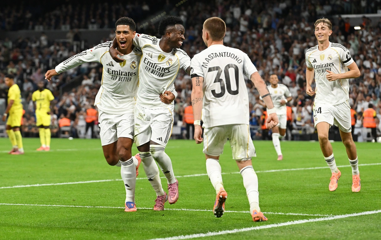 MADRID, SPAIN - OCTOBER 04: Vinicius Junior of Real Madrid celebrates with team mates Jude Bellingham and Franco Mastantuono after scoring his team's second goal during the LaLiga EA Sports match between Real Madrid CF and Villarreal CF at Estadio Santiago Bernabeu on October 04, 2025 in Madrid, Spain. (Photo by Denis Doyle/Getty Images)
