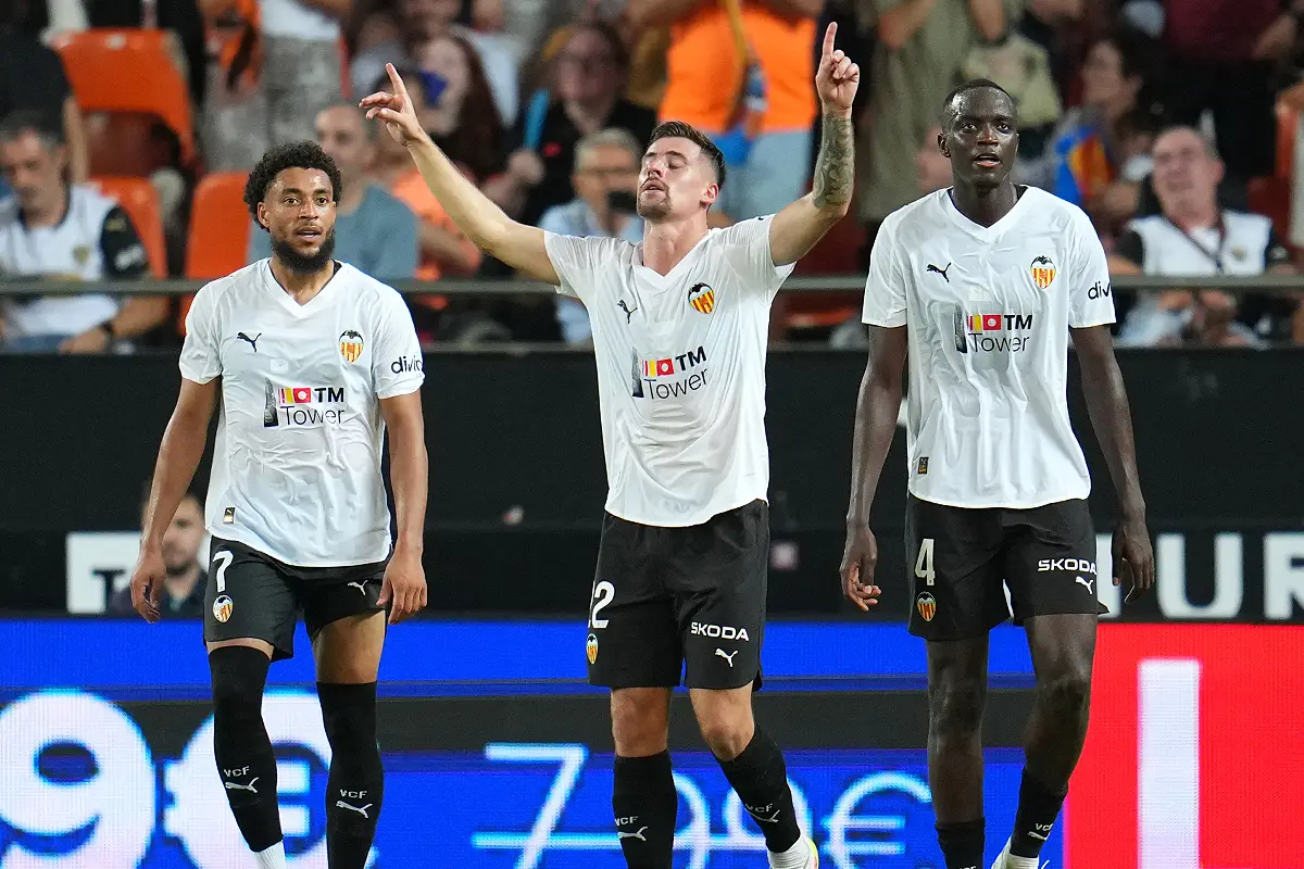 VALENCIA, SPAIN - SEPTEMBER 20: Baptiste Santamaria of Valencia CF celebrates scoring his team's first goal with teammates Arnaut Danjuma and Mouctar Diakhaby during the LaLiga EA Sports match between Valencia CF and Athletic Club at Estadi de Mestalla on September 20, 2025 in Valencia, Spain. (Photo by Aitor Alcalde/Getty Images)