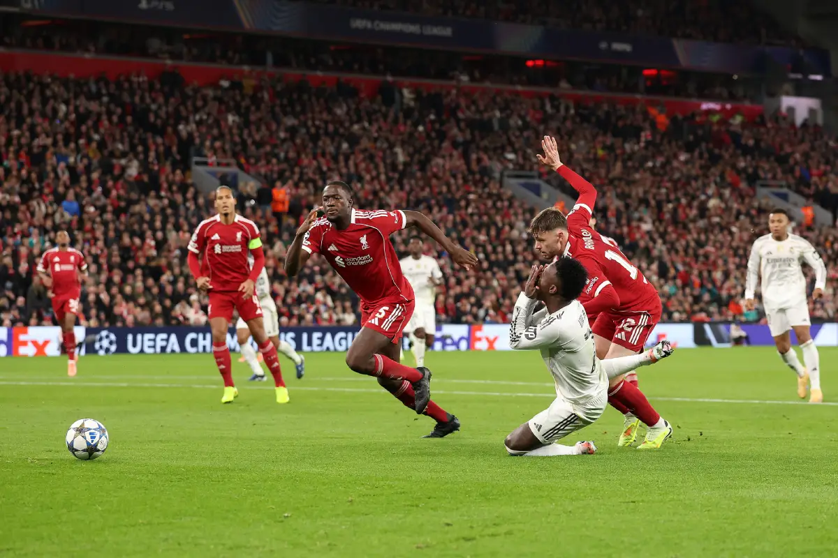 LIVERPOOL, ENGLAND - NOVEMBER 04: Vinicius Junior of Real Madrid goes down in the penalty area after being challenged by Conor Bradley of Liverpool during the UEFA Champions League 2025/26 League Phase MD4 match between Liverpool FC and Real Madrid C.F. at Anfield on November 04, 2025 in Liverpool, England. (Photo by Carl Recine/Getty Images)