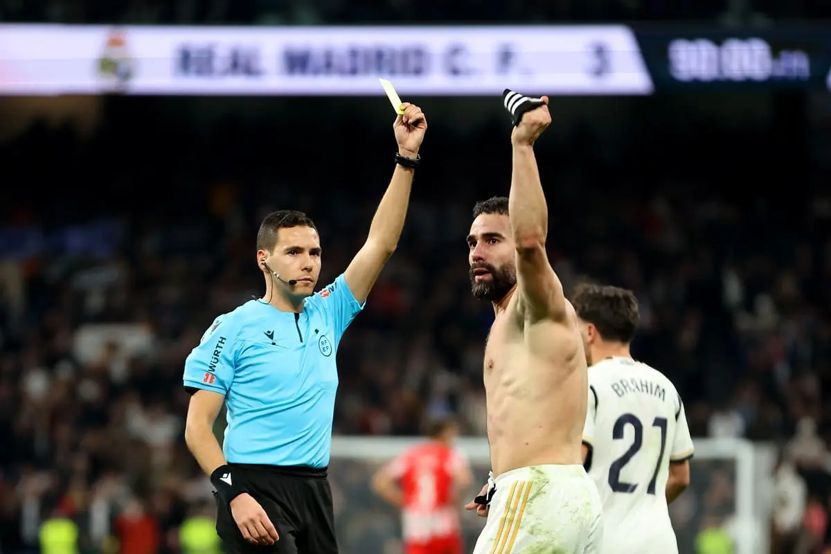 MADRID, SPAIN - JANUARY 21: Referee Francisco José Hernández Maeso gives Daniel Carvajal of Real Madrid a yellow card for his celebration after scoring the teams third goal during the LaLiga EA Sports match between Real Madrid CF and UD Almeria at Estadio Santiago Bernabeu on January 21, 2024 in Madrid, Spain. (Photo by Florencia Tan Jun/Getty Images)