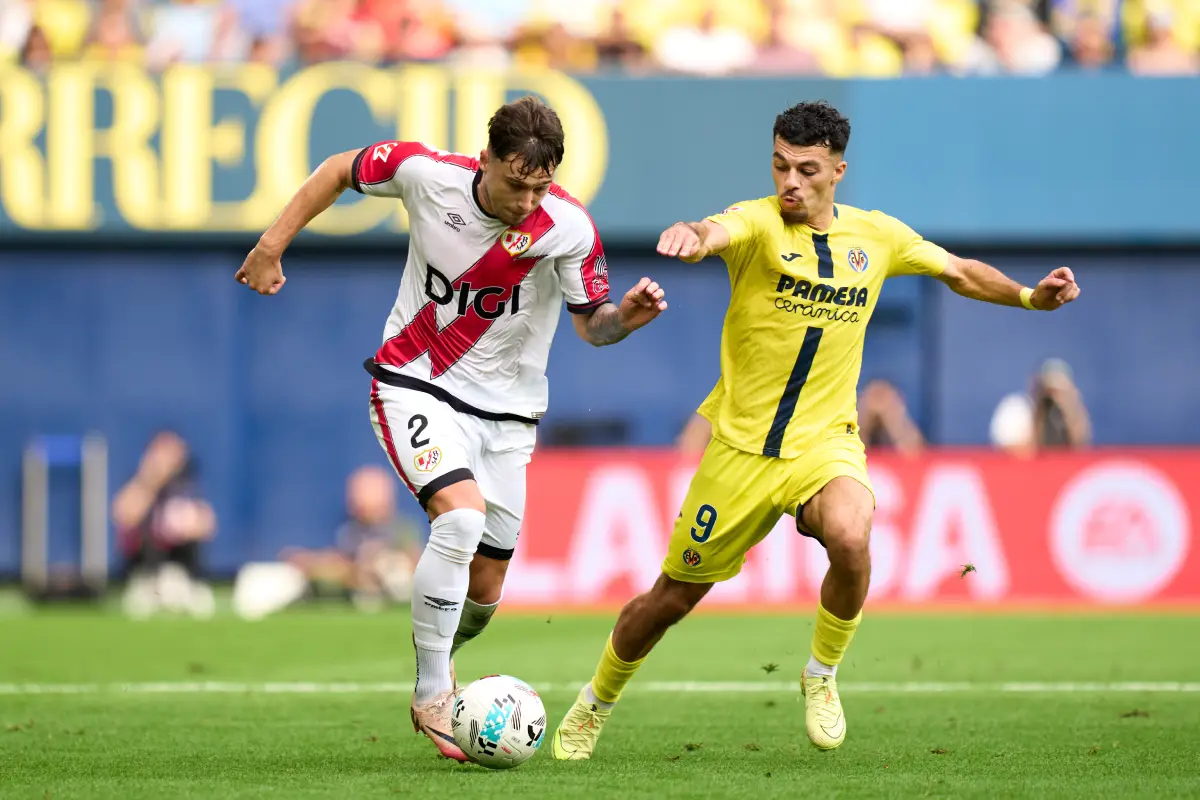 VILLARREAL, SPAIN - NOVEMBER 01: Andrei Ratiu of Rayo Vallecano and Georges Mikautadze of Villarreal CF compete for the ball during the LaLiga EA Sports match between Villarreal CF and Rayo Vallecano de Madrid at Estadio de la Ceramica on November 01, 2025 in Villarreal, Spain. (Photo by Alex Caparros/Getty Images)