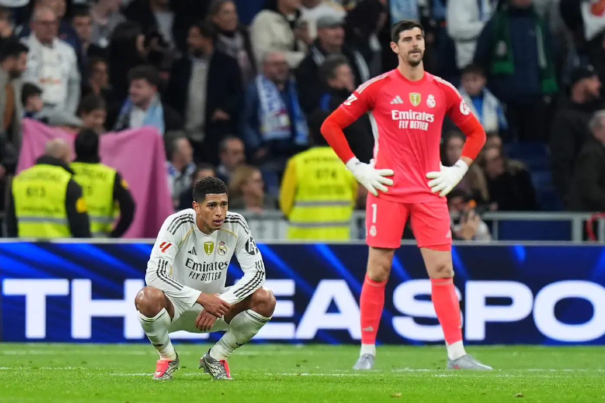 MADRID, SPAIN - DECEMBER 07: Jude Bellingham and Thibaut Courtois of Real Madrid look dejected following defeat in the LaLiga EA Sports match between Real Madrid CF and RC Celta de Vigo at Estadio Santiago Bernabeu on December 07, 2025 in Madrid, Spain. (Photo by Angel Martinez/Getty Images)