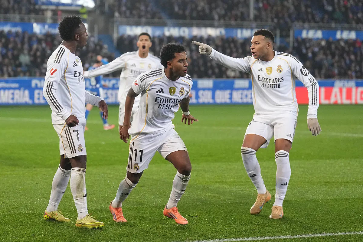 VITORIA-GASTEIZ, SPAIN - DECEMBER 14: Rodrygo of Real Madrid celebrates scoring his team's second goal with teammates Vinicius Junior and Kylian Mbappe during the LaLiga EA Sports match between Deportivo Alaves and Real Madrid CF at Estadio de Mendizorroza on December 14, 2025 in Vitoria-Gasteiz, Spain. (Photo by Juan Manuel Serrano Arce/Getty Images)