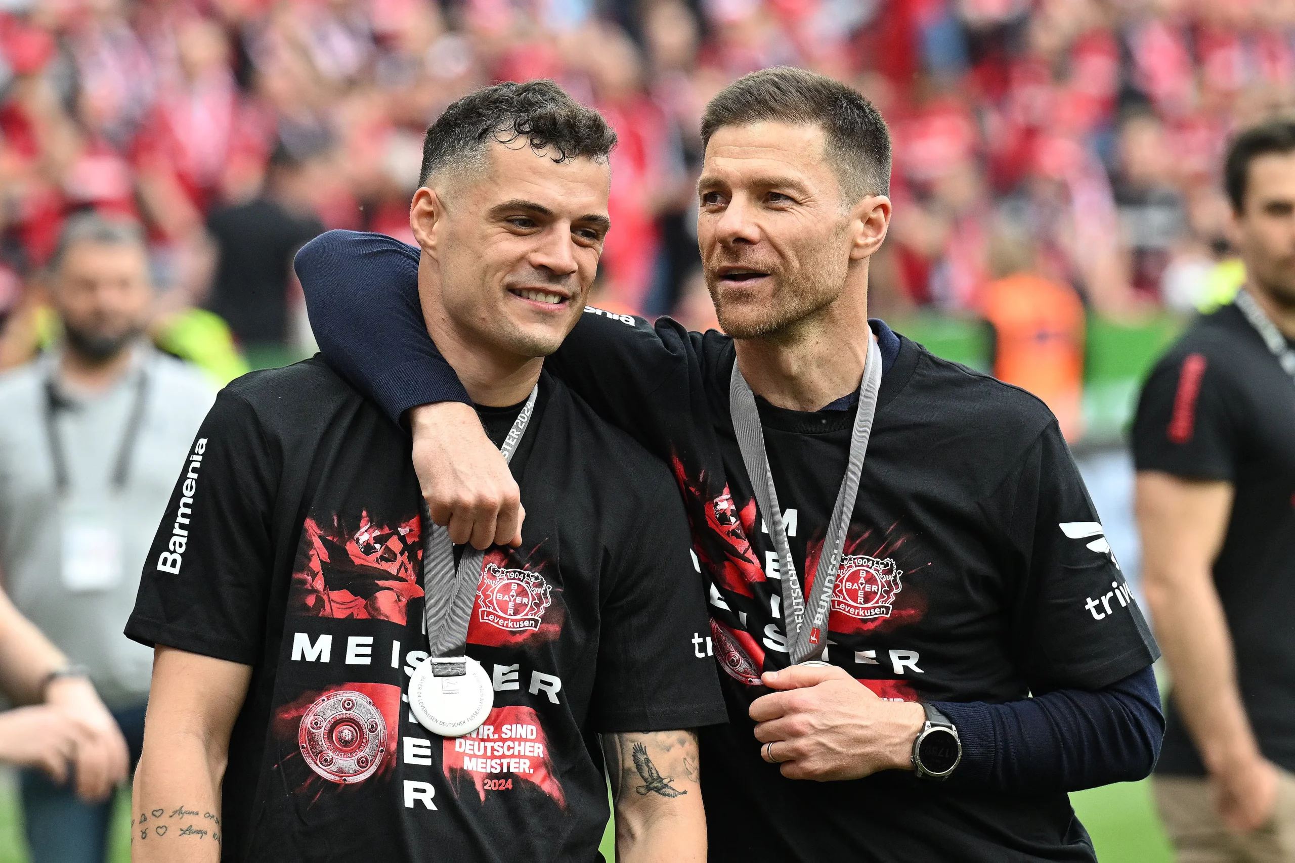 LEVERKUSEN, GERMANY - MAY 18: Granit Xhaka and Xabi Alonso, Head Coach of Bayer Leverkusen, celebrate after the team's victory during the Bundesliga match between Bayer 04 Leverkusen and FC Augsburg at BayArena on May 18, 2024 in Leverkusen, Germany. (Photo by Stuart Franklin/Getty Images)