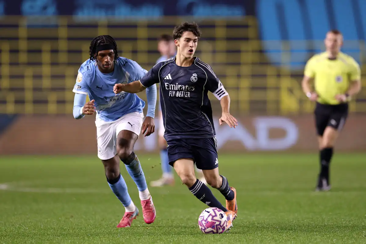 MANCHESTER, ENGLAND - DECEMBER 16: Manuel Angel of Real Madrid is challenged by Reigan Heskey of Manchester City during the Premier League International Cup match between Manchester City and Real Madrid Castilla at Joie Stadium on December 16, 2025 in Manchester, England. (Photo by Ben Roberts Photo/Getty Images).